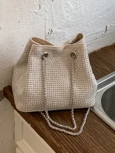 Sparkly rhinestone bucket bag with silver chain strap for women, versatile shoulder bag.