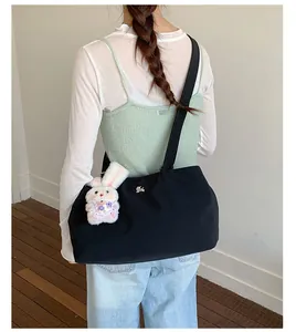 Large capacity lightweight black nylon tote bag shown on a model for casual daily use