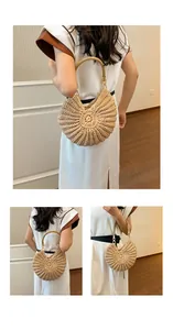 Handmade seashell shaped straw woven handbag featuring a pearl strap and elegant detail