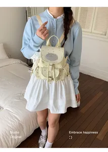 Sweet star-patterned canvas backpack worn by model in a soft-toned bedroom setting