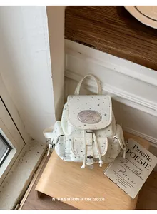 Sweet white canvas backpack with silver star pattern and buckle detail