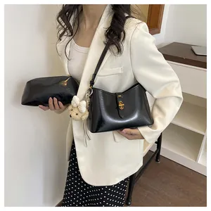 Vintage black patent leather underarm bucket bag with cute bear charm and clutch bag