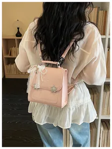 Elegante zaino rosa per studenti con stelle e fiocco in pizzo su una modella.