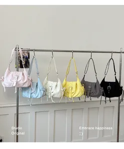 Collection of retro nylon underarm bags in various colors hanging on a display rack
