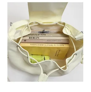 Spacious interior of vintage cream nylon commuter bag showing capacity for books