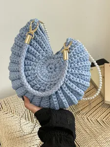 Light blue heart shaped knitted shoulder bag with pearl strap and braided handle