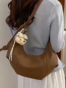 Vintage brown pleated crescent hobo bag for women featuring a cute teddy bear charm