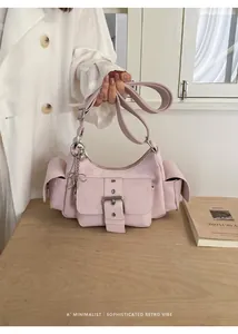 Sophisticated pink underarm bag with decorative buckle and functional multi-pocket design