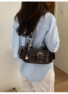 Stylish retro brown underarm bag with buckle pockets and sophisticated vibe for women