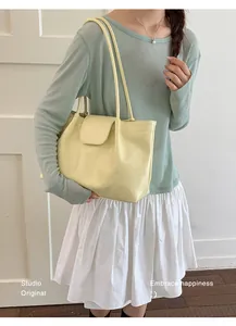 Fashionable woman carrying a large yellow pleated tote bag for a casual spring look