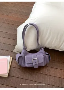Purple retro underarm shoulder bag with buckle detail on a minimalist wooden floor