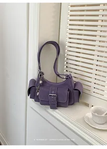 Side view of a purple retro underarm bag with multi-pocket design and silver buckle