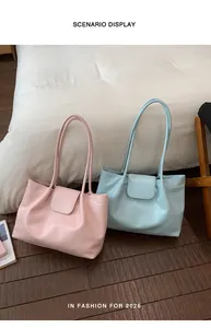 Scenario display of minimalist pleated tote bags in soft pink and light blue colors.
