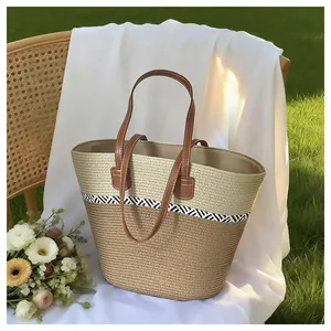 Handmade woven straw tote bag for beach vacation on a white draped chair