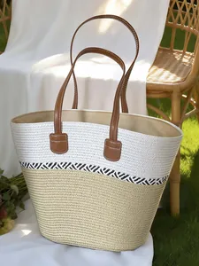 Handmade woven straw beach tote bag with brown leather handles for summer vacation