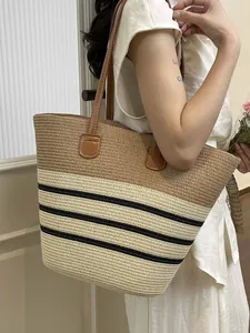 Stylish handmade straw woven tote bag with black stripes for summer beach vacations