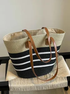 Fashionable handmade straw woven beach tote bag with black and white stripes and brown straps