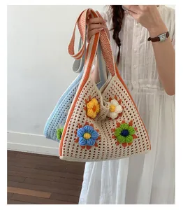 Handmade crochet shoulder bag with colorful flower patterns for summer vacation