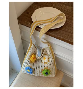 Detailed macro view of a handmade crochet tote bag with colorful 3D flower decorations