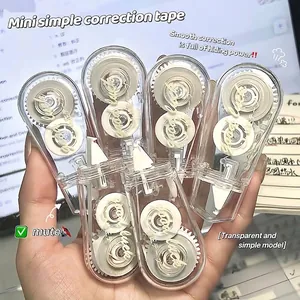 Close-up detail of five transparent silent mini correction tapes held in a person's hand