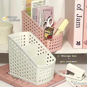 Tiered mesh desk organizer showing pens and scissors in a creative office setup