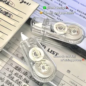 Close-up of the transparent silent correction tape featuring a minimalist 'good luck' design