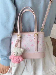 Elegant pink patterned women's bucket bag featuring a cute white plush bear keychain