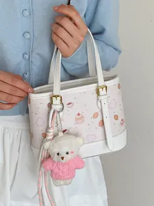 Sweet pink patterned handbag for women with cute white teddy bear charm accessory