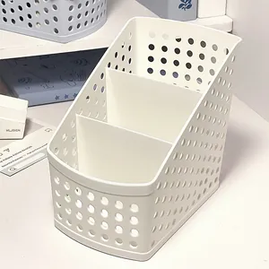 Detailed view of a white multi-compartment plastic desk organizer with a sleek mesh design