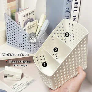 Detail view of a 3-compartment creamy white desktop organizer for stationery items