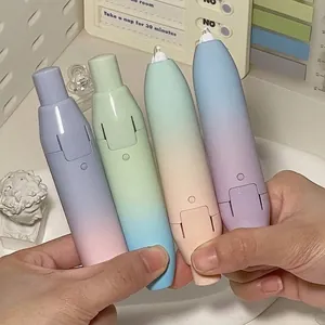 Macro view showing four macaron gradient push-type correction tapes held by hands