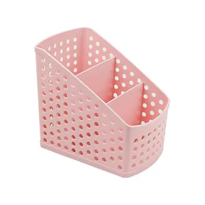 Pink multi-compartment desk organizer with decorative hollow design for office storage