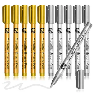 Close-up showing the soft nib and shimmering ink of silver metallic brush pens