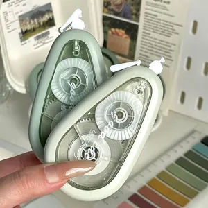 Macro view of teardrop-shaped correction tapes in mint and sage green color tones