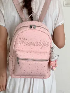 Mochila de lona rosa elegante con motivos de estrellas y bordados