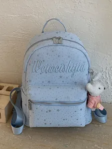 Mochila de lona azul claro con estampado de estrellas, bordado y colgante de conejo