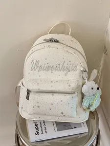 Mochila escolar de lona crema con estrellas plateadas y diseño de bordado elegante