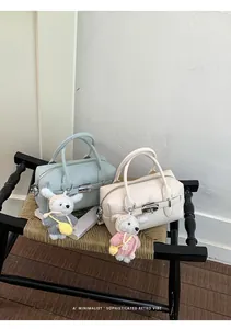 Sophisticated lychee textured bowling bags in mint and cream with cute rabbit charms