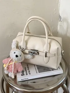Minimalist cream white lychee grain bowling handbag featuring a cute rabbit charm