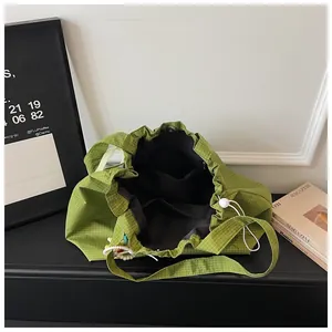 Interior view of a green checkered large capacity canvas tote bag with pockets