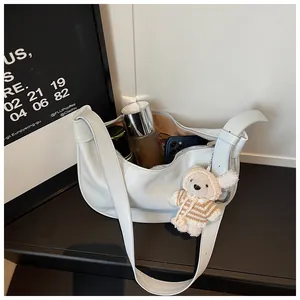 Detailed interior view of a stylish white faux leather dumpling bag showing capacity.
