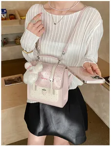Young woman carrying a pink polka dot backpack with strawberry patch and rabbit charm