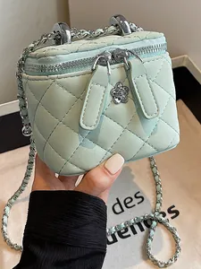 Elegant mint green quilted box bag with a silver chain strap and flower zipper pull