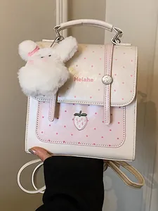 Cute Korean style polka dot backpack with strawberry embroidery and plush rabbit charm.