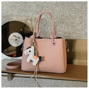 Elegant pink textured bucket bag with cute white horse charm and dual knot handles