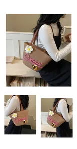 Handwoven straw beach bag with embroidered "Summer" text and floral detail for ladies.