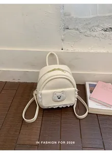 Cream white mini backpack featuring a cute bear patch and elegant lace trim details