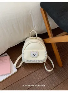 Detailed view of cute white women's backpack with bear patch and delicate lace trim