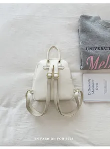 Back view of cute white mini backpack with adjustable straps and gold buckles
