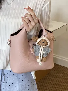 Elegante rosafarbene Eimertasche aus Leder mit niedlichem Teddybär-Plüsch-Schlüsselanhänger